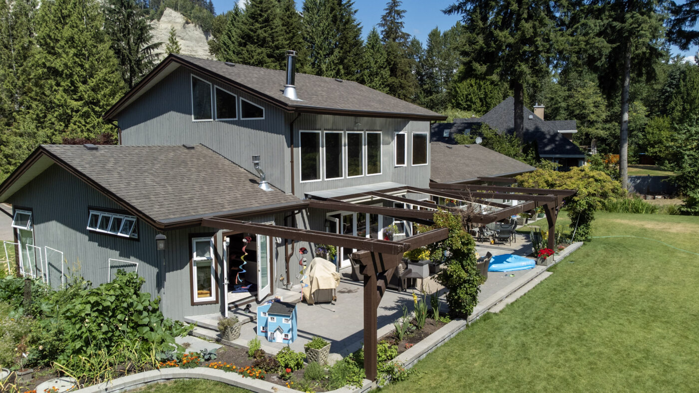 A single house with a patio and a garden. This house was painted by Armstrong Custom Decoriating